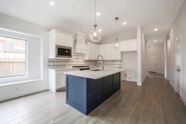 4030 Colony Ln, Missouri City, TX 77459 - kitchen featuring stainless steel appliances, custom range hood, a sink, decorative backsplash, and light countertops