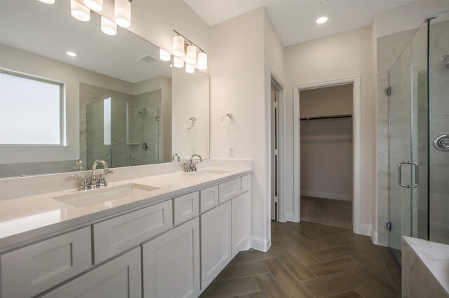 4030 Colony Ln, Missouri City, TX 77459 - full bathroom with a walk in closet, a stall shower, double vanity, and baseboards