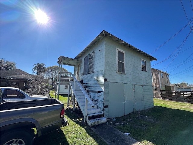 view of property exterior with a yard