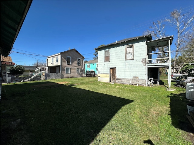 back of property featuring a lawn