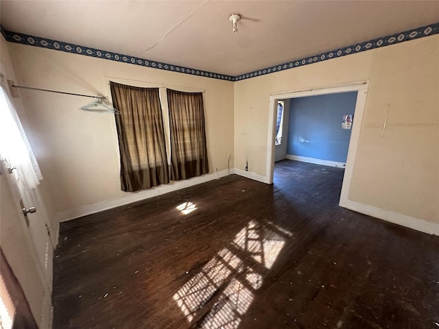 spare room with dark hardwood / wood-style floors