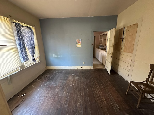 unfurnished bedroom with dark hardwood / wood-style floors