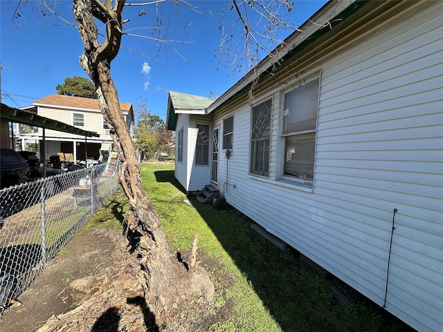 view of property exterior with a lawn