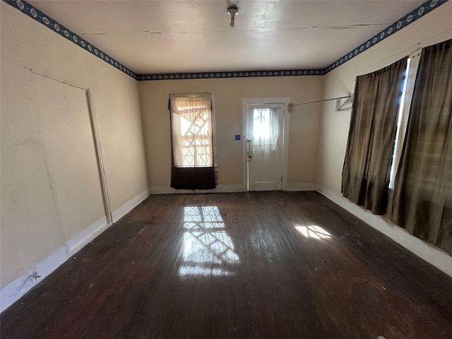 empty room featuring dark wood-type flooring