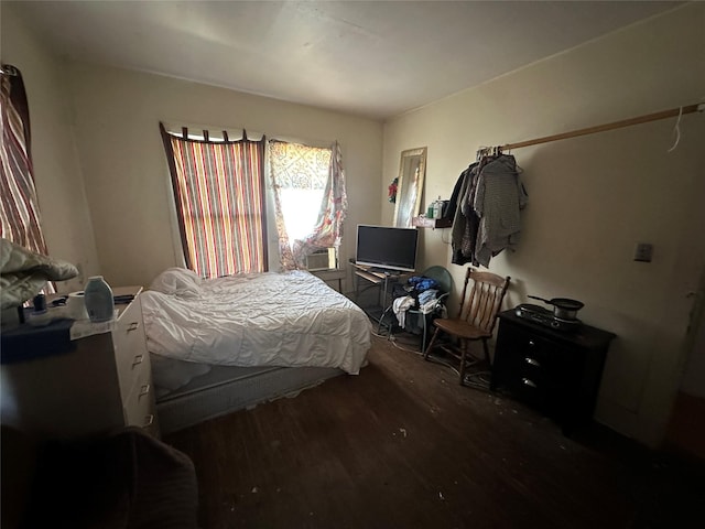 bedroom with dark hardwood / wood-style flooring