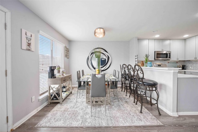 dining room with plenty of natural light and hardwood / wood-style floors