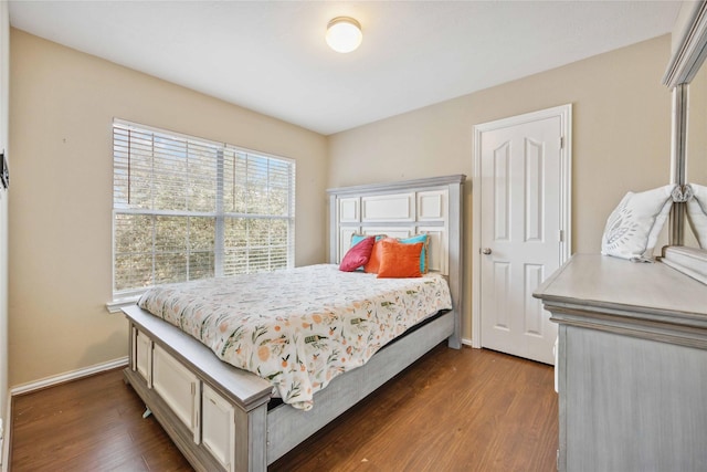 bedroom with dark hardwood / wood-style flooring