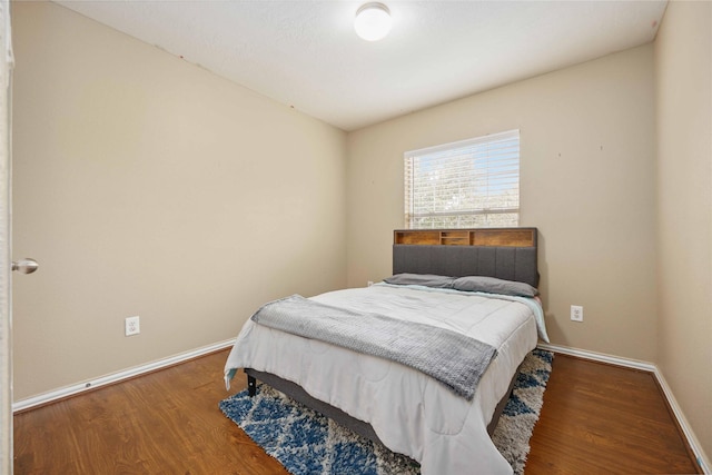 bedroom with wood-type flooring