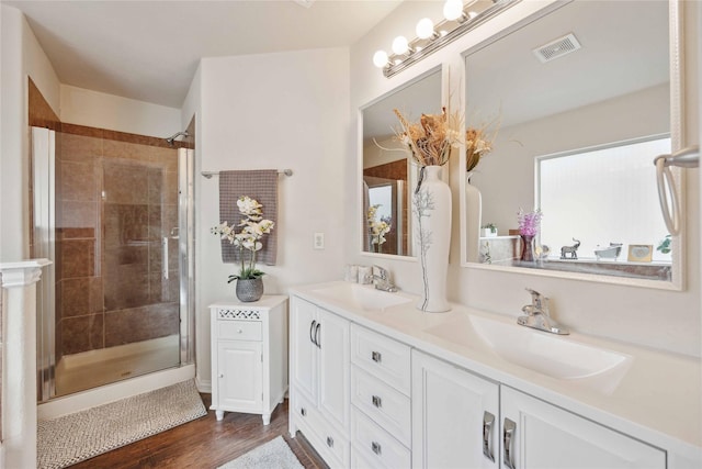 bathroom with vanity, hardwood / wood-style flooring, and walk in shower