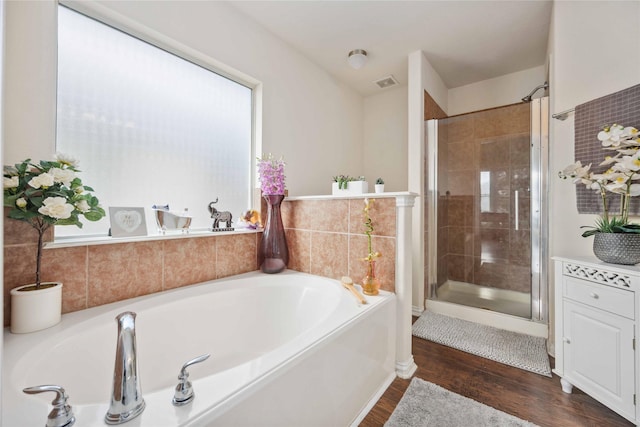 bathroom with separate shower and tub and hardwood / wood-style floors