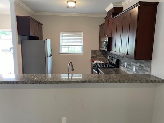 kitchen featuring stone counters, sink, stainless steel appliances, backsplash, and ornamental molding