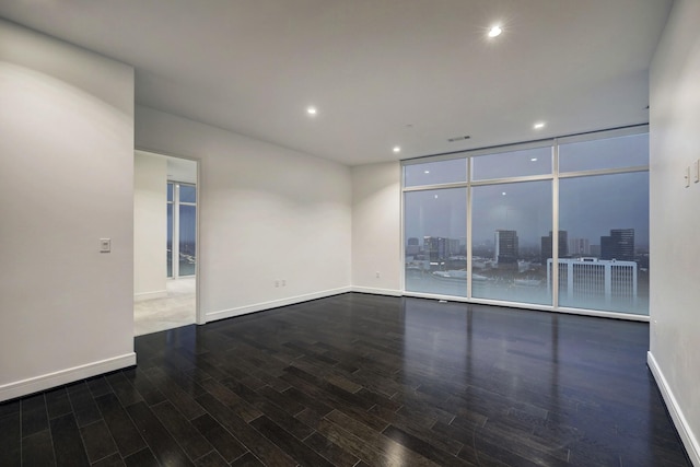 unfurnished room with expansive windows