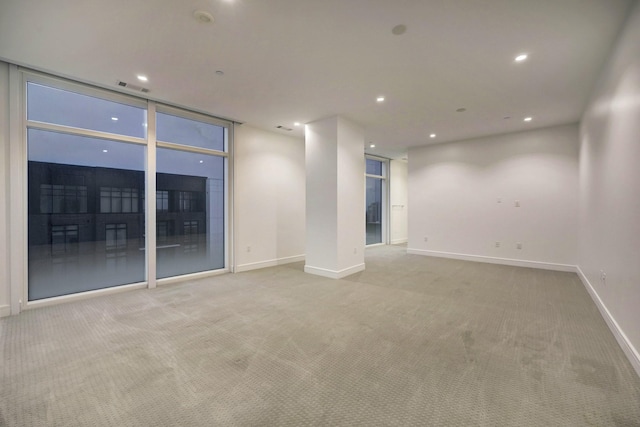 carpeted empty room with expansive windows