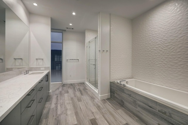 bathroom featuring shower with separate bathtub, vanity, and hardwood / wood-style flooring