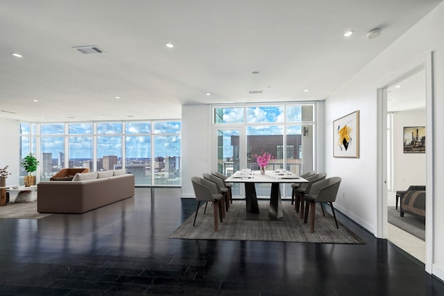 dining space featuring dark hardwood / wood-style floors and floor to ceiling windows