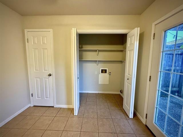 laundry area with light tile patterned floors and hookup for a washing machine