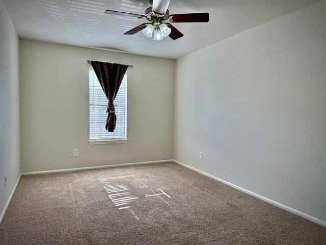 empty room featuring ceiling fan and carpet floors