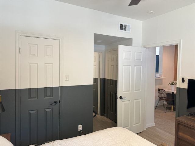 bedroom with hardwood / wood-style floors and ceiling fan