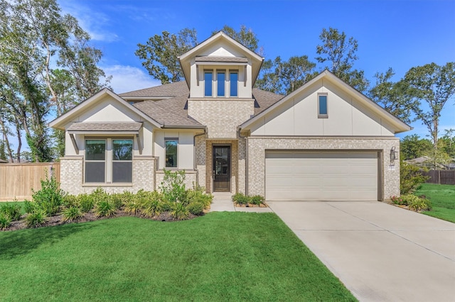 view of front of house featuring a garage and a front lawn