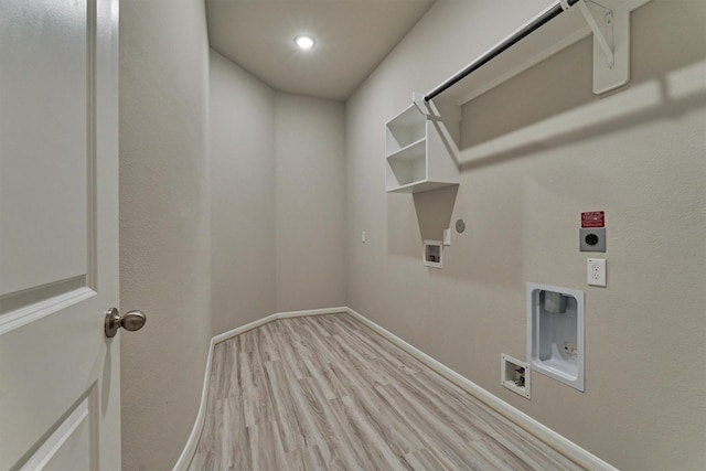 clothes washing area featuring hookup for an electric dryer, hookup for a washing machine, light hardwood / wood-style floors, and gas dryer hookup