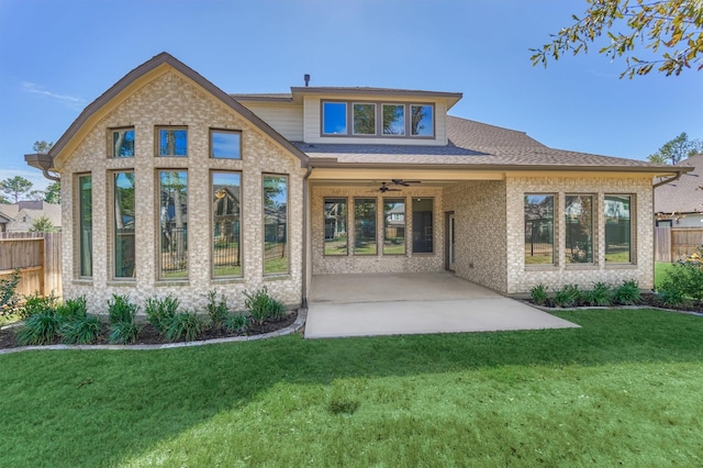 back of property featuring a lawn, ceiling fan, and a patio area