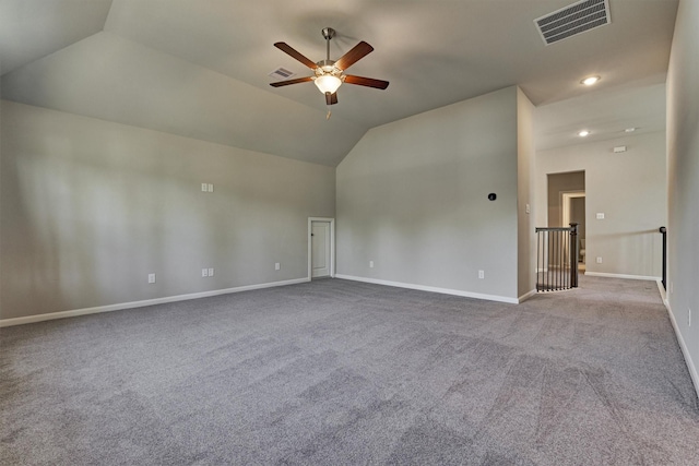 carpeted empty room with ceiling fan and vaulted ceiling