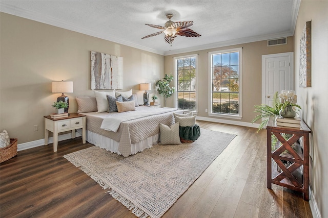 bedroom with wood-type flooring, a textured ceiling, ceiling fan, and crown molding