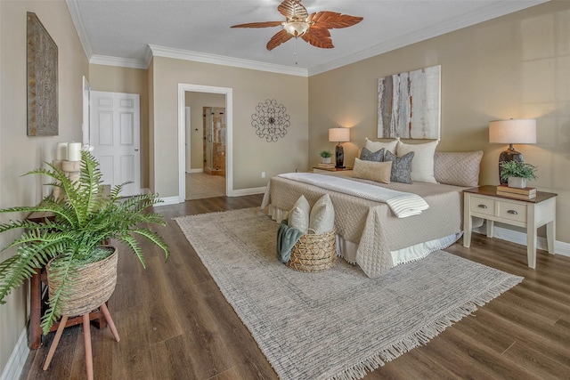 bedroom with dark hardwood / wood-style floors, ensuite bath, ceiling fan, and crown molding