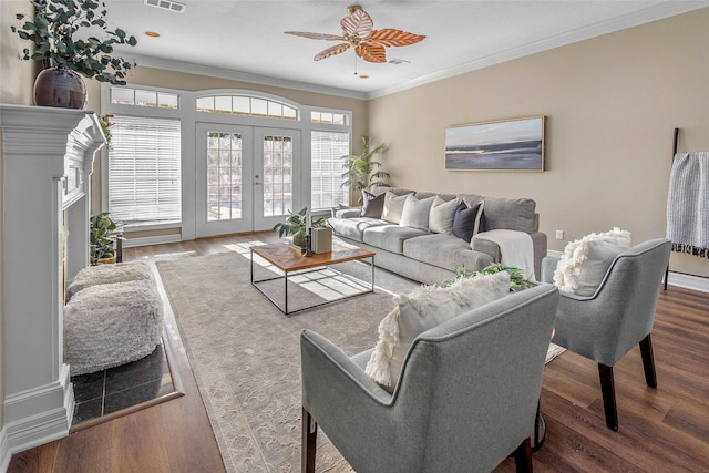 living room featuring dark hardwood / wood-style floors, ceiling fan, crown molding, and french doors