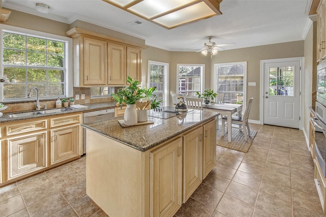 kitchen with stainless steel dishwasher, ceiling fan, a center island, and stone counters