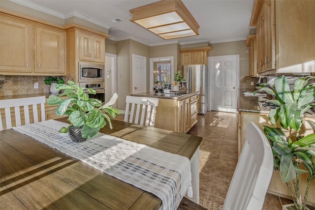 tiled dining room featuring crown molding