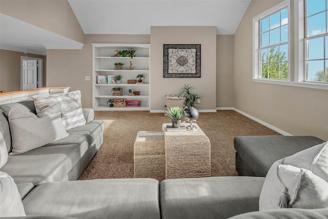 carpeted living room with built in shelves and vaulted ceiling