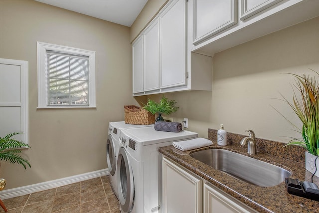 clothes washing area with cabinets, independent washer and dryer, light tile patterned flooring, and sink