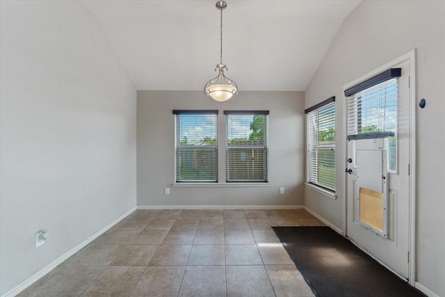 interior space featuring light tile patterned floors and vaulted ceiling