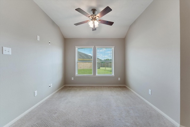 carpeted spare room featuring ceiling fan and lofted ceiling