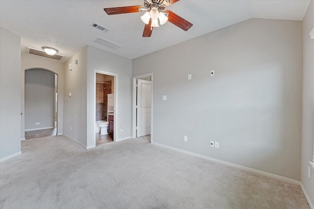 carpeted empty room with ceiling fan and lofted ceiling