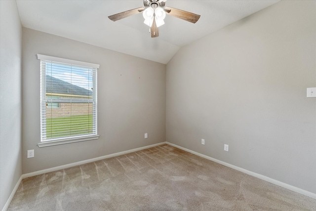 carpeted spare room featuring ceiling fan and lofted ceiling