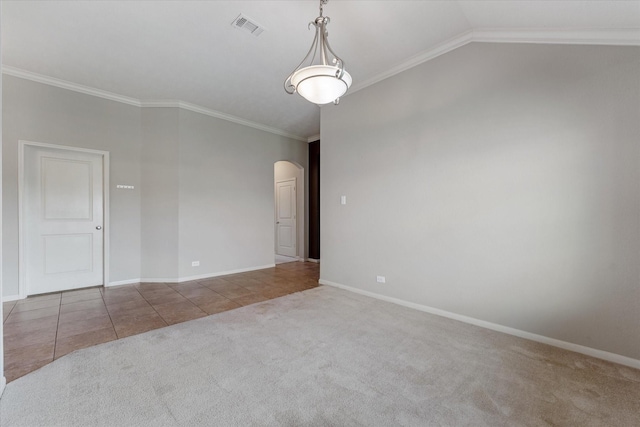 spare room featuring lofted ceiling, carpet floors, and crown molding