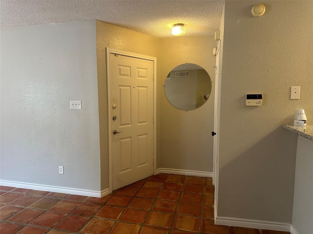 foyer featuring a textured ceiling