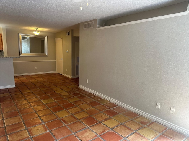 empty room featuring a textured ceiling