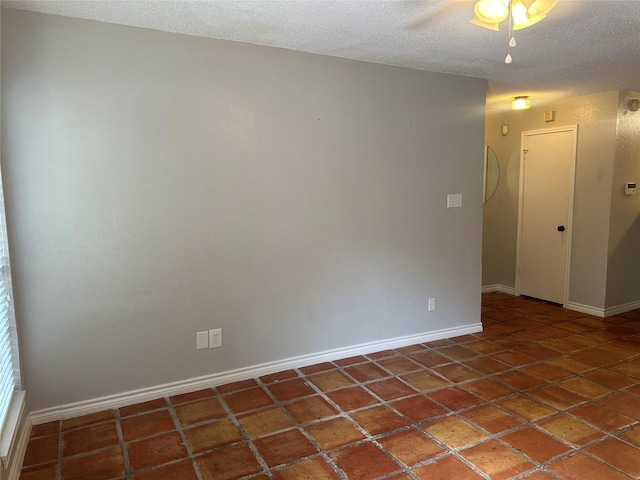 unfurnished room featuring a textured ceiling