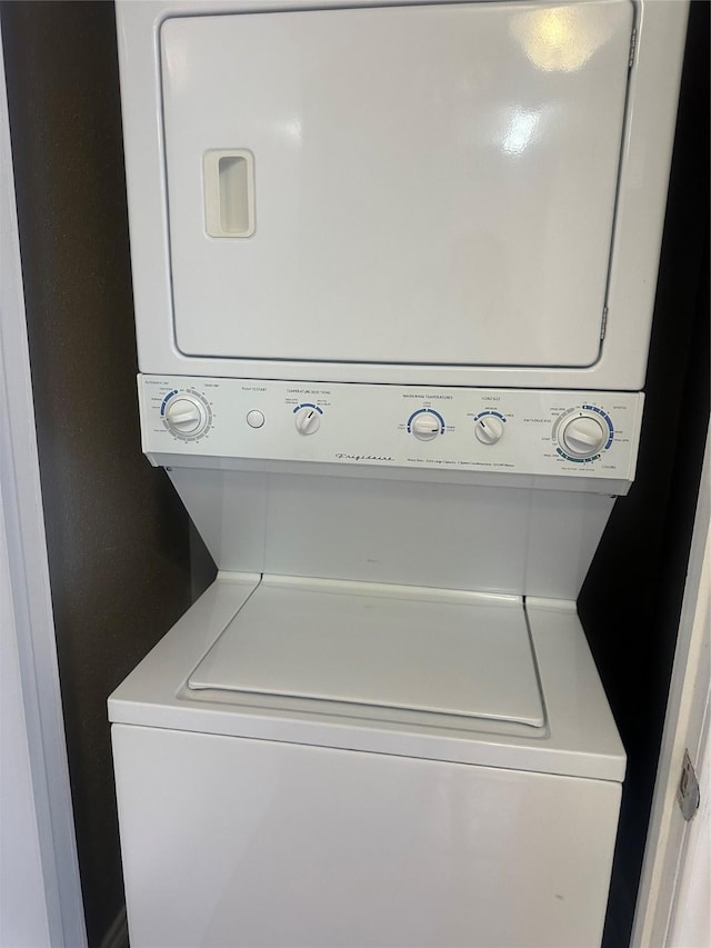 laundry room with stacked washer / drying machine