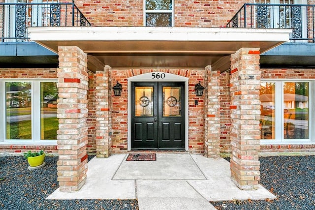 doorway to property featuring covered porch and a balcony