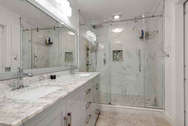 bathroom featuring vanity, a shower with door, and ornamental molding