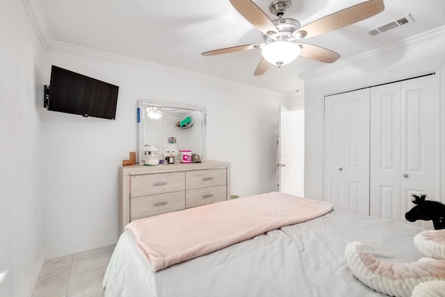 tiled bedroom featuring crown molding, a closet, and ceiling fan