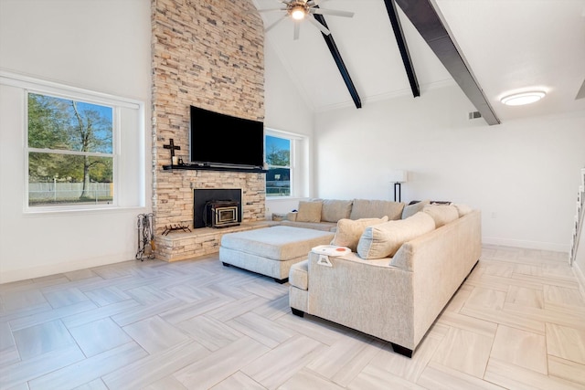 living room with light parquet floors, ceiling fan, beam ceiling, high vaulted ceiling, and a wood stove