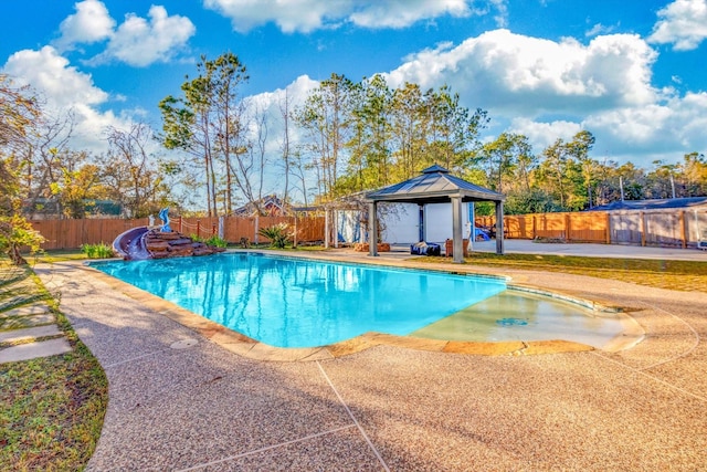 view of pool featuring a gazebo, a patio, and a water slide