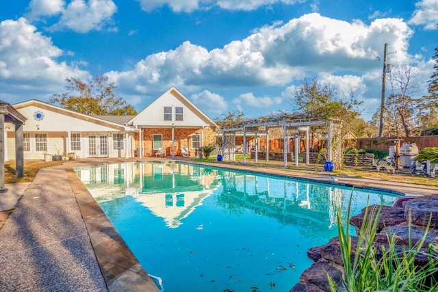 view of swimming pool featuring a pergola and a patio area