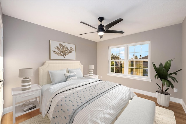 bedroom with ceiling fan and wood-type flooring