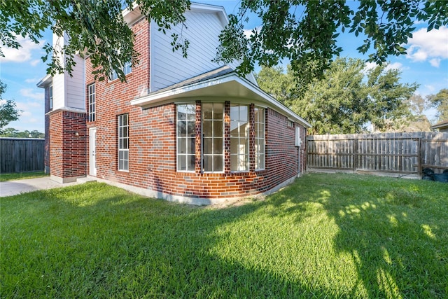 view of side of home featuring a yard